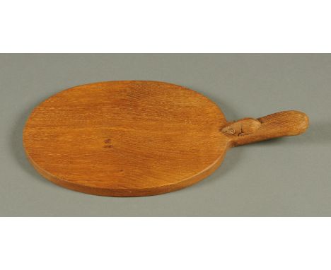 A Mouseman Thompson of Kilburn oak cheese board, with mouse trademark.  Length 40 cm.  CONDITION REPORT: First class conditio