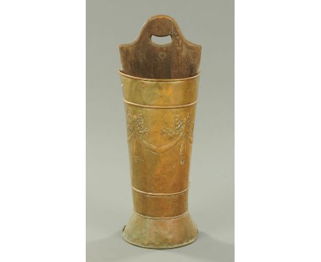 A late 19th century brass stick and umbrella stand, embossed with bows.  Height 83 cm. 