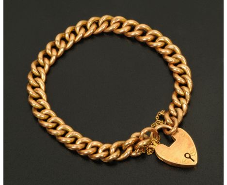 A 9 ct gold hollow link curb bracelet with padlock and safety chain, each link marked, 12 grams. 