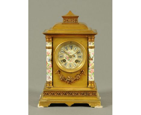 A porcelain and brass cased mantle clock, French, with two-train striking movement.  height 29 cm, width 19 cm. 