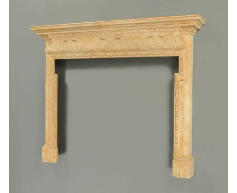 A carved pine fire surround, in the George III style, with moulded cornice above a foliate carved frieze.  Width 178 cm, heig