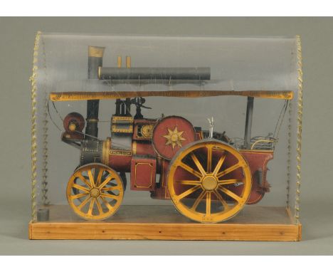 A cased model of a steam engine "Excelsior", painted cardboard.  Case length 33 cm. 