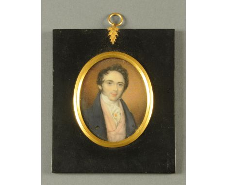 A portrait miniature, Georgian gentleman wearing a blue coat and pink waistcoat, oval.  84 mm x 70 mm, in ebonised frame with