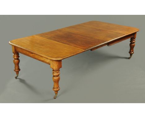 A Victorian mahogany wind out dining table, with two leaves, with moulded edge, rounded corners, recessed frieze and raised o