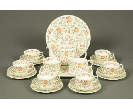 A Minton Haddon Hall tea set, six cups, six saucers, six plates, sandwich tray, teapot, sugar basin and milk jug and with two