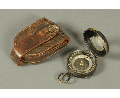 A First World War leather cased brass and painted metal compass.
