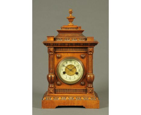 A Victorian walnut mantle clock, with two-train fourteen day movement with paper label "Made in Wurttenberg".  Height 44 cm. 