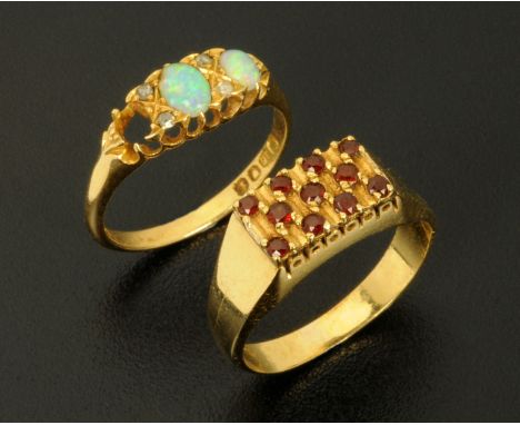 A gold coloured ring set with ruby coloured stones, size O, and an 18 ct gold opal ring, size M, (stone missing). 