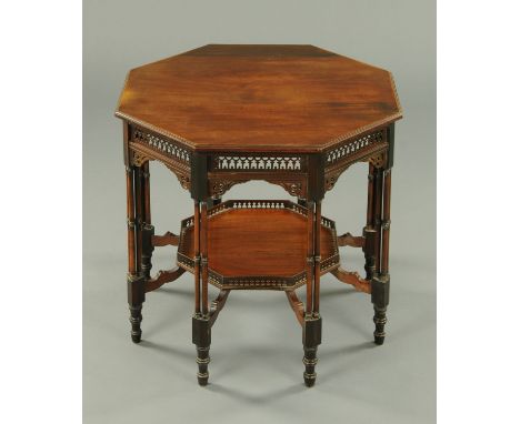 An Edwardian mahogany octagonal occasional table, with fretwork frieze and raised on cluster column legs united by a low shel