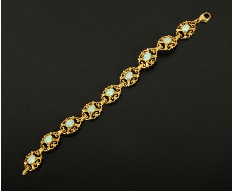 A 9 ct gold fancy link bracelet, each link set with an opal.