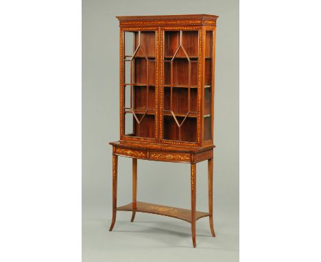 A late 19th/early 20th century side cabinet by Jas. Schoolbred, with moulded dentil cornice above a pair of glazed doors with