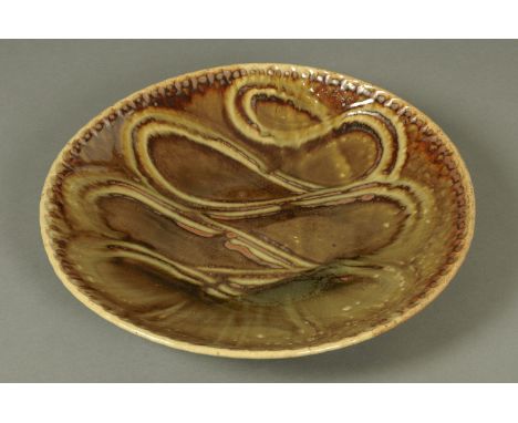 Edward Hughes (1953-2006), a large olive glazed charger, with figure of eight decoration, impressed "EH" monogram.  Diameter 