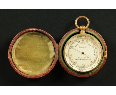 A cased pocket barometer, brass, by Gray & Selby, Nottingham.  Diameter 48 mm. 