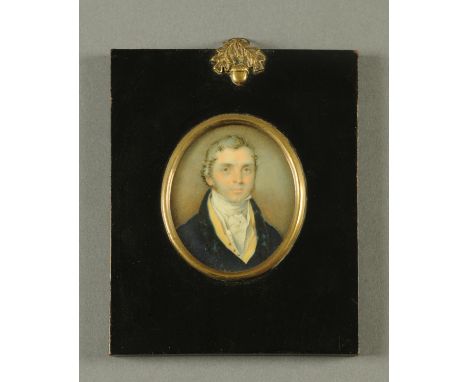 A portrait miniature, on ivory, Georgian gentleman wearing a blue coat and yellow waistcoat, oval.  77 mm x 66 mm, in ebonise