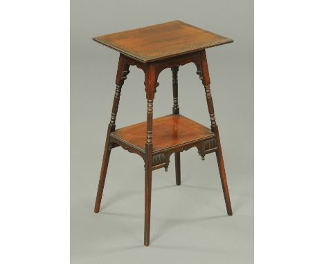 An Edwardian rosewood occasional table, with rectangular top, splayed, turned and fluted legs and raised shelf.  Width 35 cm.