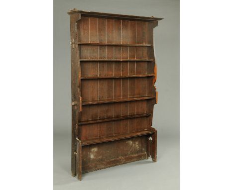 An oak Arts & Crafts shelf unit, with silhouette sides with stylised piercings.  Width 140 cm.