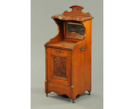 An Edwardian walnut fall front coal receiver, with shelf and mirror above, raised on castors.  Width 43 cm. 