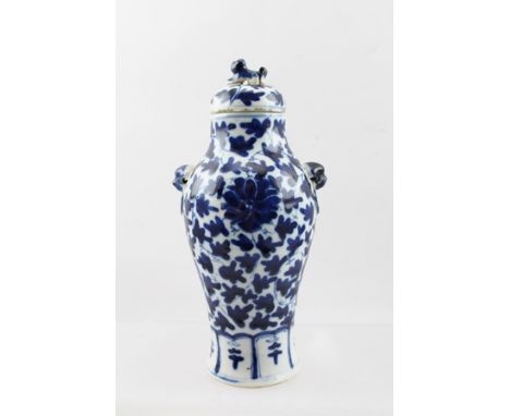 A CHINESE BLUE AND WHITE PORCELAIN VASE of baluster form with ring mask handles and cover, four character marks to base, 21.5