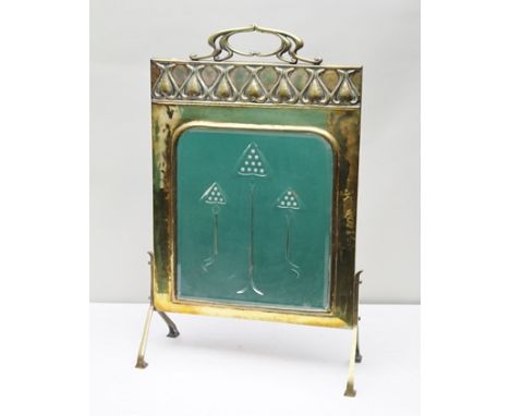 AN ARTS AND CRAFTS DESIGN BRASS FIRESCREEN IN THE MANNER OF VOYSEY, the top with cast tendril handle, embossed crest of flora