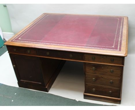 A 19TH CENTURY MAHOGANY TWIN PEDESTAL PARTNER'S DESK, the top inset with gilt tooled burgundy leather writing surface, fitted