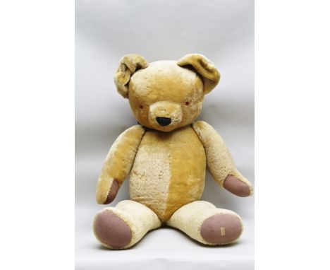 A "MERRYTHOUGHT" LARGE SIZED GOLDEN PLUSH ARTICULATED TEDDY BEAR, wearing a colourful silk neckerchief, having orange and bla