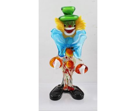 A MID TO LATE 20TH CENTURY MURANO GLASS CLOWN, wearing green top hat, blue bow tie and typically large black shoes, 22cm high