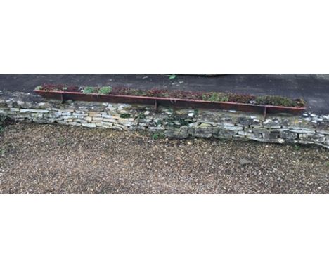 A VINTAGE CAST IRON PIG TROUGH bearing the impressed makers mark "Plenty Newbury", length 3m 