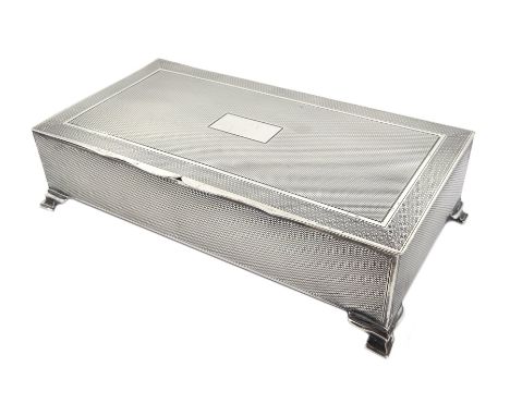 Silver cigarette case, engine turned decoration and cartouche to lid, on ogee bracket feet by Hasset &amp; Harper Ltd, Birmin