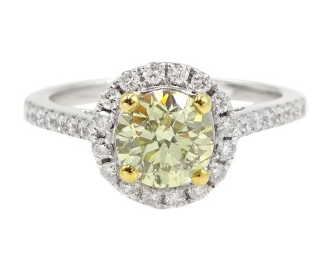 18ct white gold diamond halo ring, the central round brilliant cut fancy yellow diamond of 1.02 carat, with white diamond sur