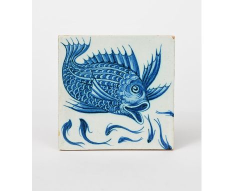 An early William De Morgan tile, painted in blue with a large scaly fish swimming in a shoal of smaller fish unsigned, 15.5 x