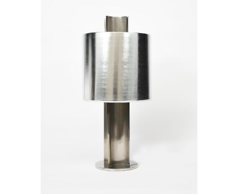 A large polished steel table lamp and shade, retailed by Heal's, disc base supporting four curved panels flanking central squ
