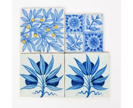 A pair of early William De Morgan tiles, painted with a spray of berried foliage in blue on a white ground, a tile decorated 