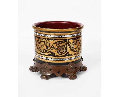 A large Bretby Pottery jardiniere in the manner of Dr Christopher Dresser, drum form, on flaring foot, printed with stylised 