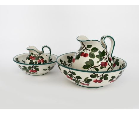 A Wemyss Ware Cherry wash basin and ewer, painted with sprays of fruiting cherry in green and black on a white ground, and an
