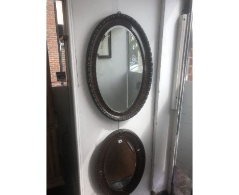 An oval oak mirror