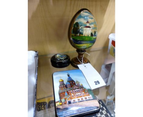 A Russian lacquerware decorative egg,  probably made from birch wood, the reserve decorated with a lake scene, together with 