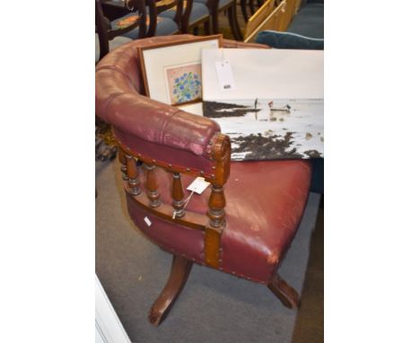 A button back leather upholstered mahogany swivel desk chair. 