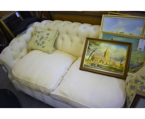 A small cream upholstered button back salon sofa. 