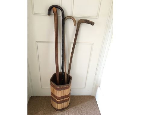 Bamboo stick stand and four walking sticks.