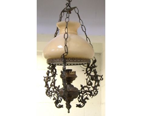A brass ceiling light with ornate brass frame.