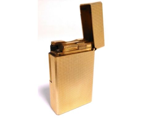 An S.T. Dupont of Paris gold plated lighter.