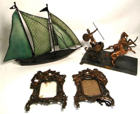 A pair of vintage copper photograph frames decorated with knights on horseback to the top and a metal and ceramic boat, also 