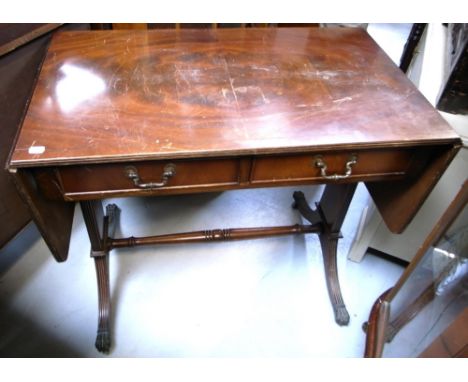 A reproduction mahogany sofa table with ring turned stretcher, fluted legs terminating in paws and castors, width when fully 