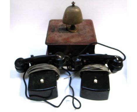 A vintage desk telephone, a vintage wall mounted telephone and a telephone exchange bell mounted upon a mahogany wooden case 