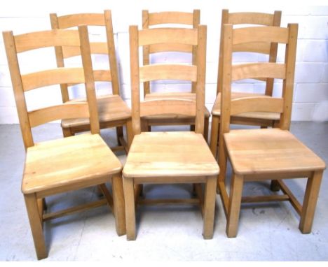 A set of six contemporary light oak dining chairs on block supports (6).