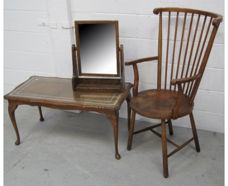 An early 20th century stick back elbow chair, a shaped rectangular glass topped coffee table raised on cabriole legs, a free 