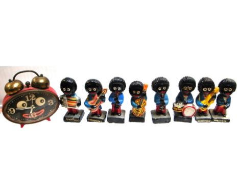 Eight assorted musical Golly figurines and red Golly alarm clock (9).
