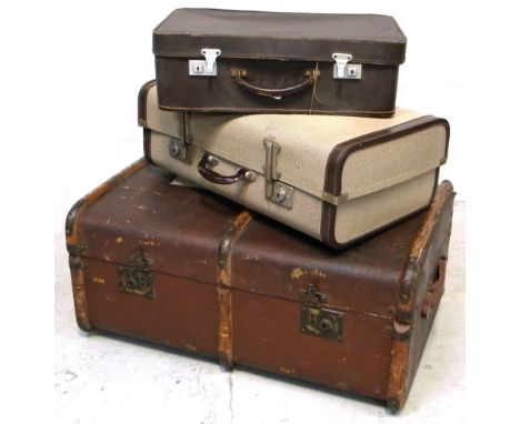 A 20th century leather and wooden bound travelling trunk with brass fittings and two vintage suitcases (3).