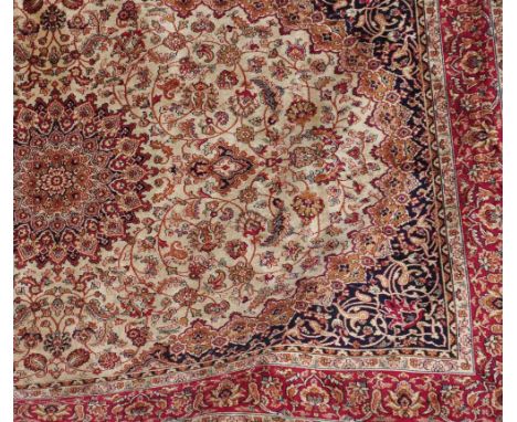 A beige ground Keshan carpet, the central floral motif surrounded by a border of floral sprays, 230 x 160cm.