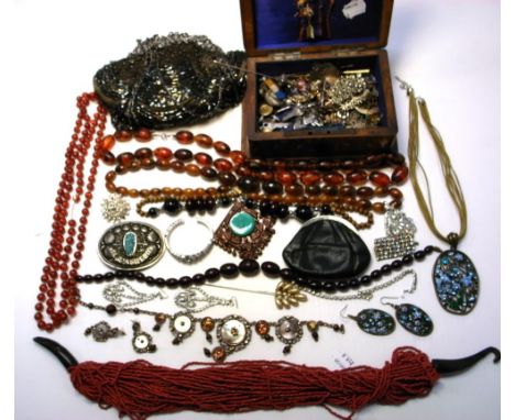 A quantity of costume jewellery and jewellery box to include necklaces, brooches and amber coloured beads, also a vintage eve